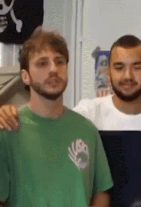 Bearded Man in Green Shirt Next to Man in White Shirt