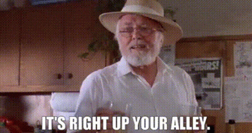 Bearded Man in Hat and Glasses Holding Wine