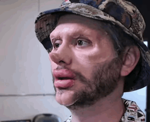 Bearded Man in Hat Sticking Tongue Out