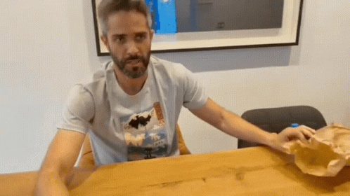 Bearded Man in Hawaii T-Shirt at Table