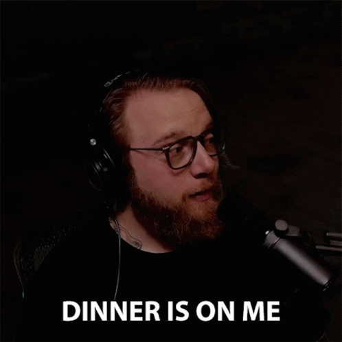 Bearded Man in Headphones and Glasses Says Dinner Is on Me