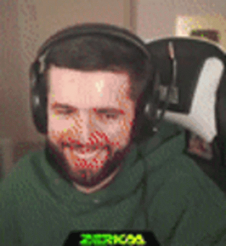 Bearded Man in Headphones and Green Hoodie Smiling
