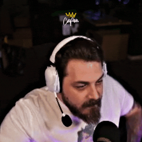 Bearded Man in Headphones With Mic Saying Capon