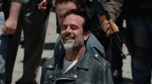 Bearded Man in Leather Jacket Smiling in Crowd