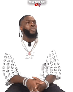 Bearded Man in Mike Adel Abu Shirt Hands Folded