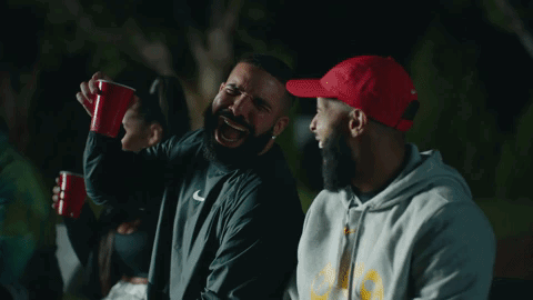 Bearded Man In Nike Jacket Laughing With Another Man GIF
