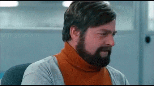 Bearded Man in Orange Turtleneck and Gray Shirt