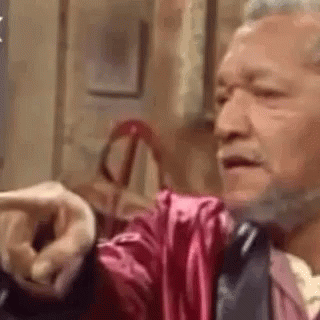 Bearded Man in Pink Robe Pointing