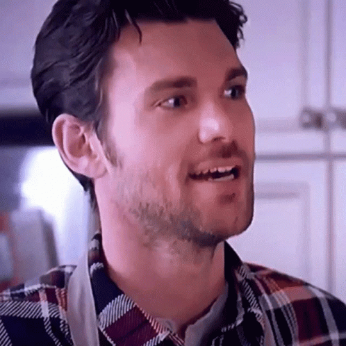 Bearded Man in Plaid Shirt and Apron Smiling
