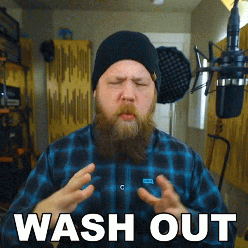 Bearded Man in Plaid Shirt and Black Hat Saying Wash Out