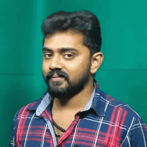 Bearded Man in Plaid Shirt Looking at Camera