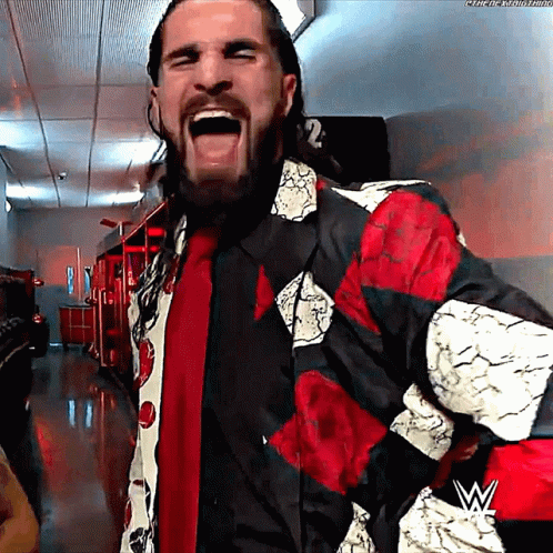 Bearded Man in Red and Black Jacket With W Logo