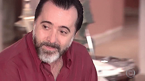 Bearded Man in Red Shirt Looking at Camera