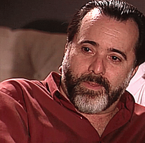 Bearded Man in Red Shirt Looking at Camera