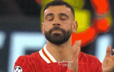 Bearded Man in Red Shirt With Arabic Writing