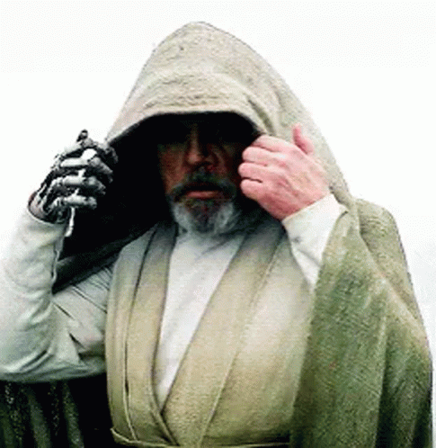 Bearded Man in Robe Holding Lightsaber