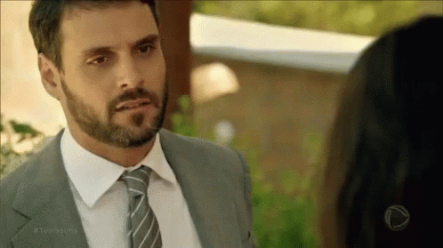 Bearded Man in Suit and Tie Looking at Woman