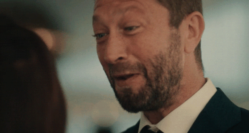Bearded Man In Suit And Tie Looking At Woman GIF