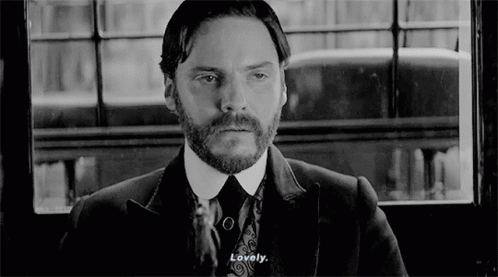 Bearded Man In Suit And Tie Looking Out Window GIF