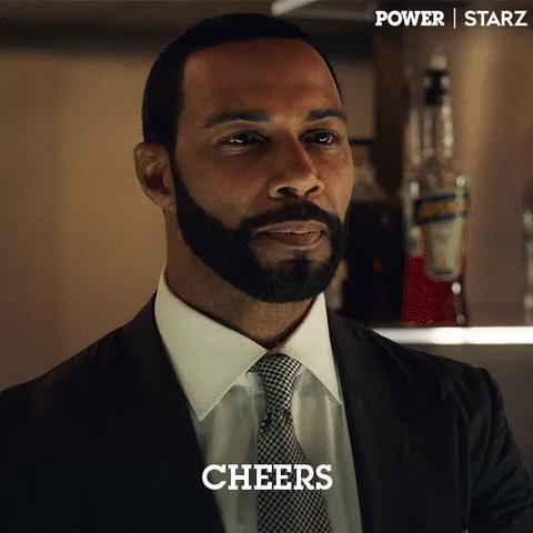 Bearded Man In Suit And Tie Saying Cheers GIF