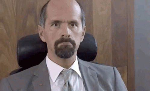 Bearded Man In Suit And Tie Sitting GIF