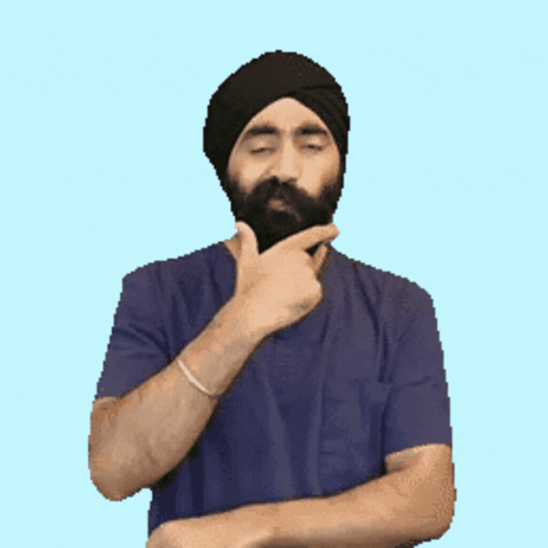 Bearded Man in Turban and Blue Shirt Thinking