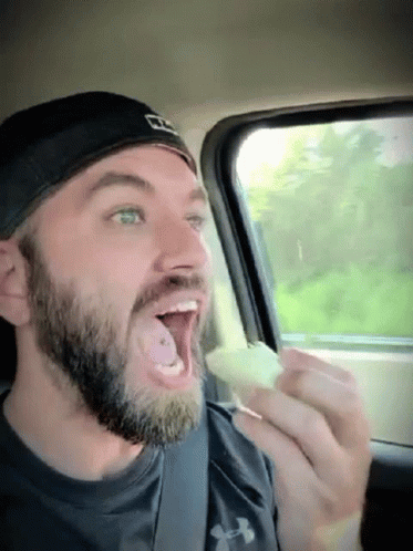 Bearded Man in Under Armour Shirt Eating