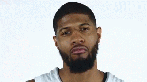 Bearded Man in White Jersey Looks at Camera