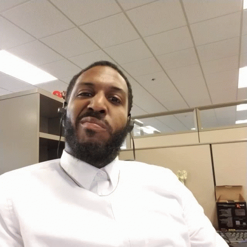 Bearded Man in White Shirt Looking Down