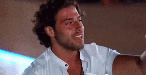 Bearded Man In White Shirt Sitting At Table GIF