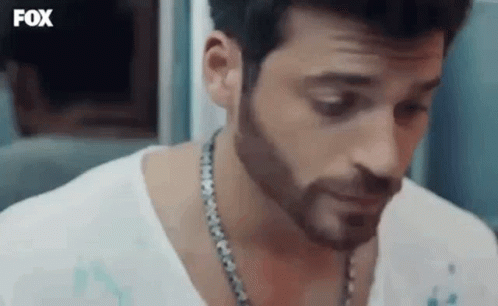 Bearded Man in White Shirt With Chain