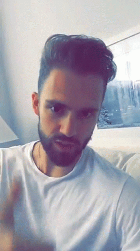 Bearded Man In White T-Shirt On Couch GIF