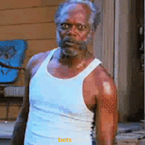 Bearded Man in White Tank Top Saying Bets
