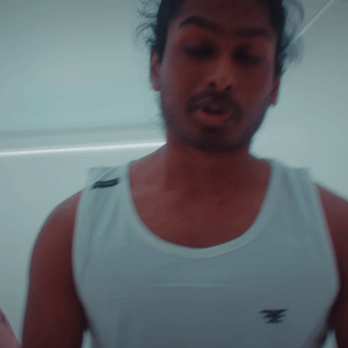Bearded Man in White Tank Top with E