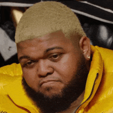 Bearded Man In Yellow Jacket With Letter N GIF