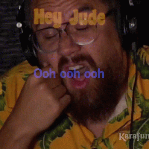 Bearded Man In Yellow Shirt And Headphones Saying Ooh GIF