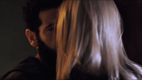 Bearded Man Kissing Woman With Long Hair