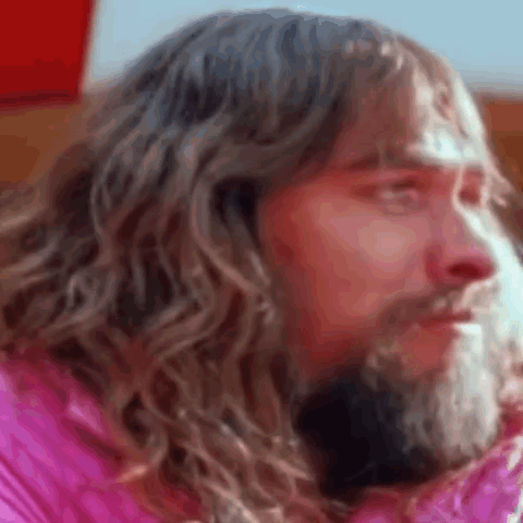 Bearded Man Long Hair Pink Jacket Looking Camera