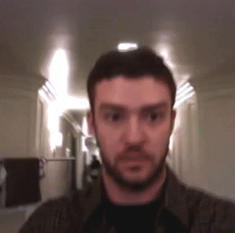 Bearded Man Looking at Camera in Hallway