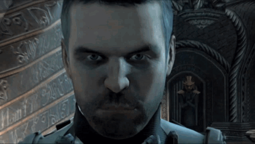 Bearded Man Looking At Camera With X On Wall GIF