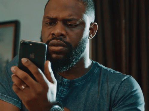 Bearded Man Looking at Phone Eyes Closed