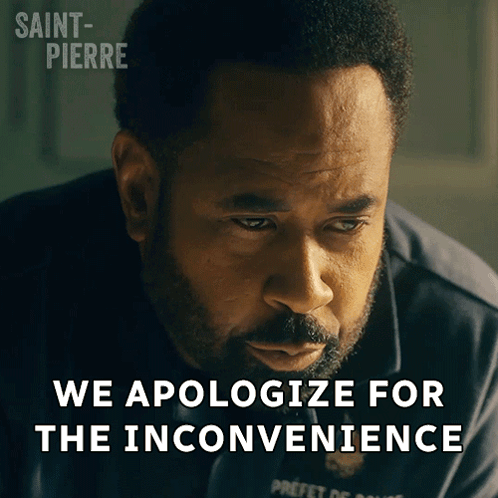 Bearded Man Looking Down Saying We Apologize for the Inconvenience