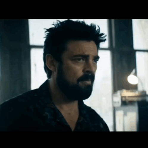 Bearded Man Looking in Dark Room