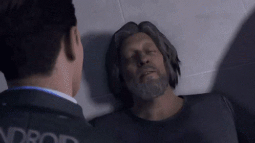 Bearded Man Lying on Floor With Eyes Closed Another Man Watching