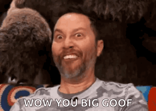 Bearded Man Making Funny Face at Stuffed Animal
