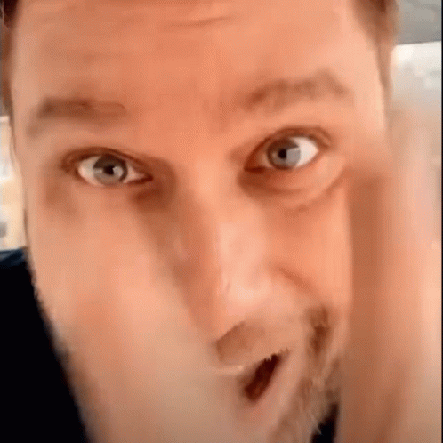 Bearded Man Making Funny Face Hand to Face