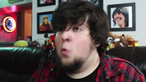 Bearded Man Making Funny Face In Front Of Coca Cola Sign GIF