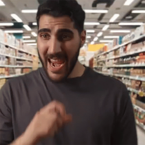 Bearded Man Making Funny Face in Grocery Aisle