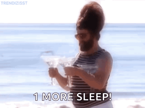 Bearded Man on Beach Holding Martini and Newspaper