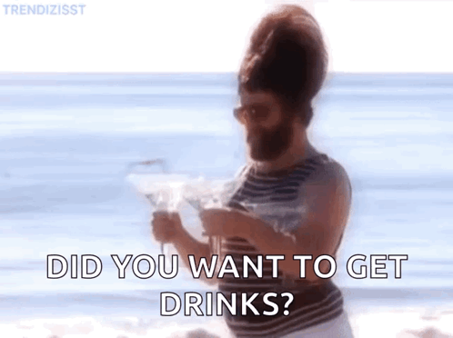 Bearded Man on Beach Holding Martini Asking If He Wants Drinks